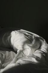 white textile on black textile