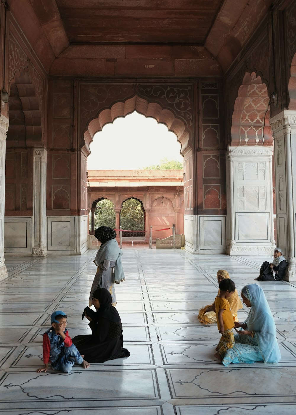 people sitting on brown floor tiles