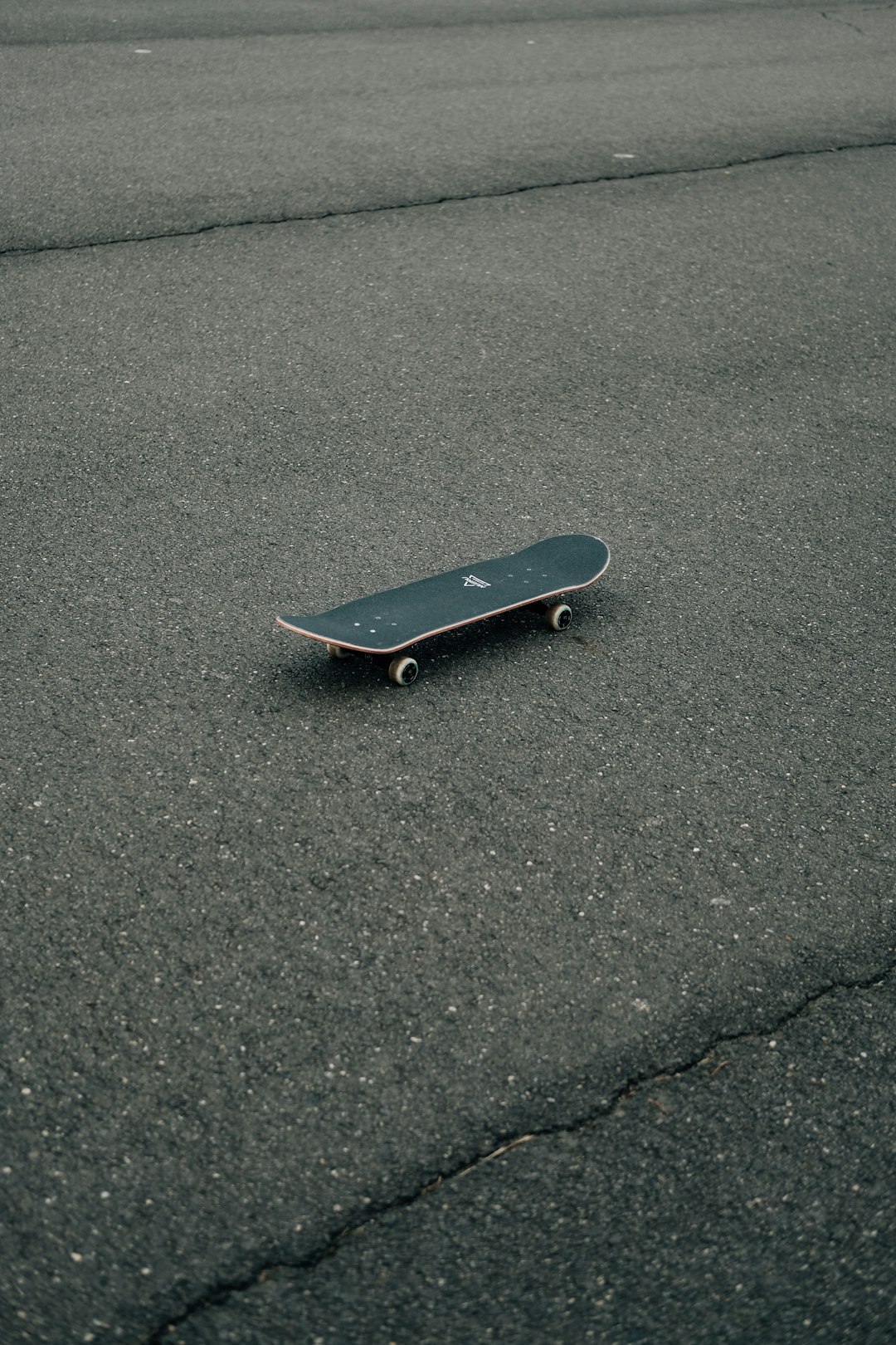 black skateboard on gray concrete floor