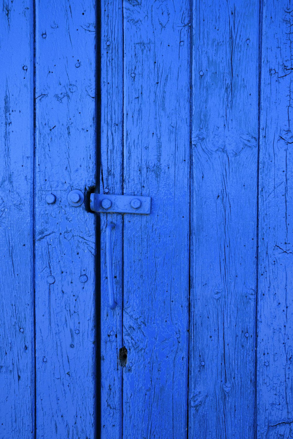 blue wooden door with padlock