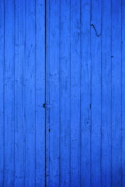 blue wooden door with black metal door handle
