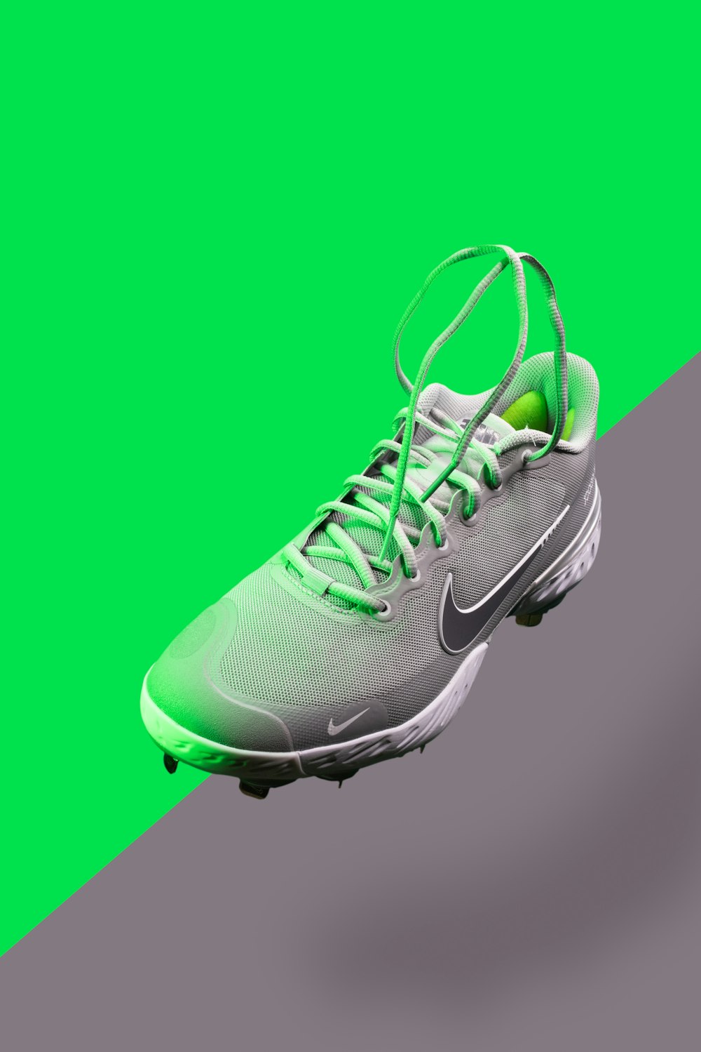 green and white nike athletic shoe
