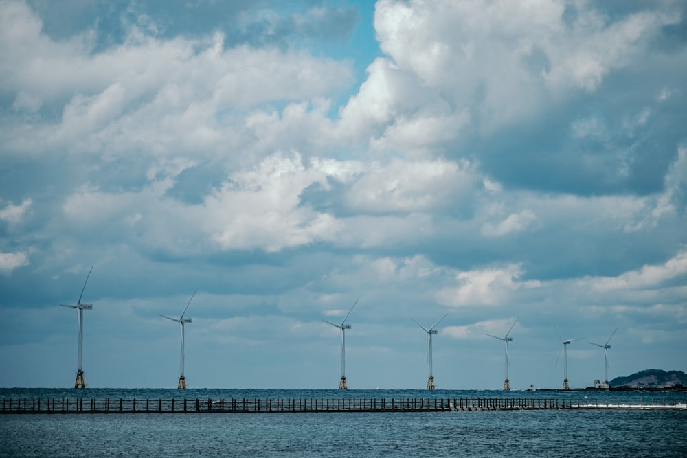 brown wooden dock under white clouds during daytime