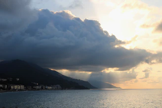 A detailed weather radar map showing approaching storm clouds over a coastal area.