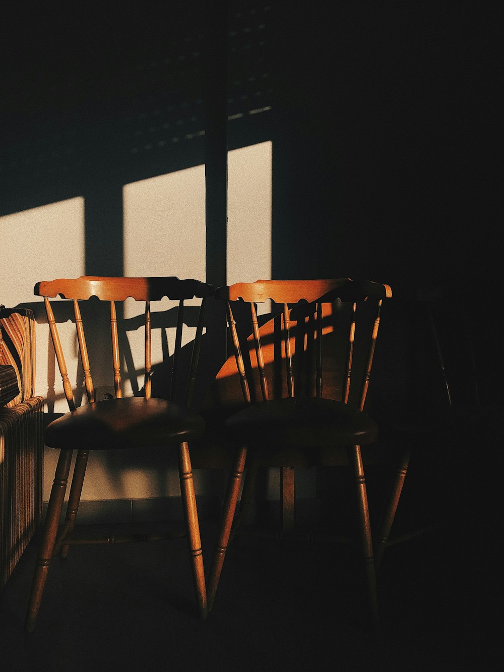 brown wooden chair near window