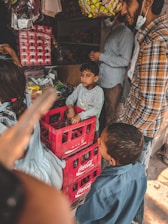 A friendly Campa Cola distributor handing over a crate of bottles to a local shop owner.