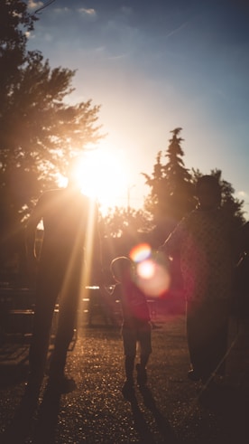 man in red jacket standing on pathway during daytime