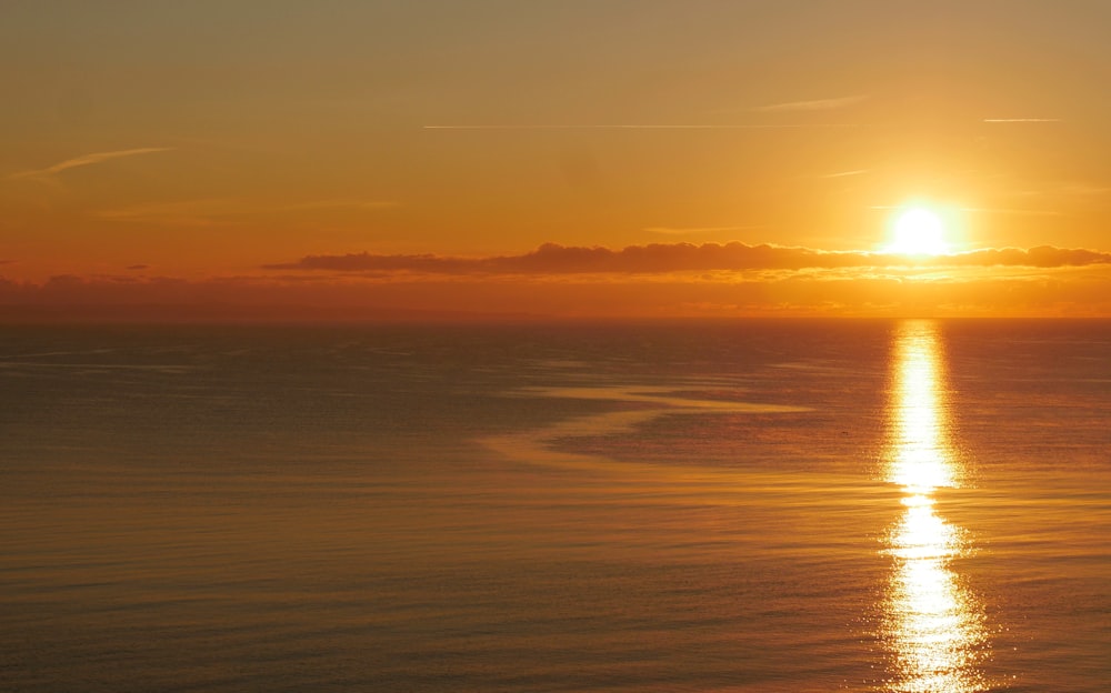 body of water during sunset