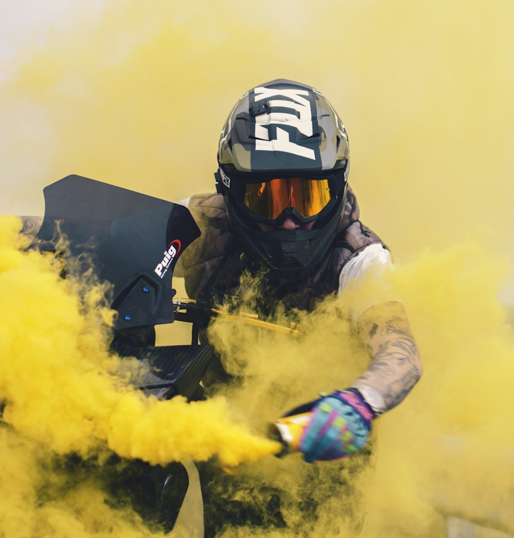 man in black helmet and yellow and black jacket