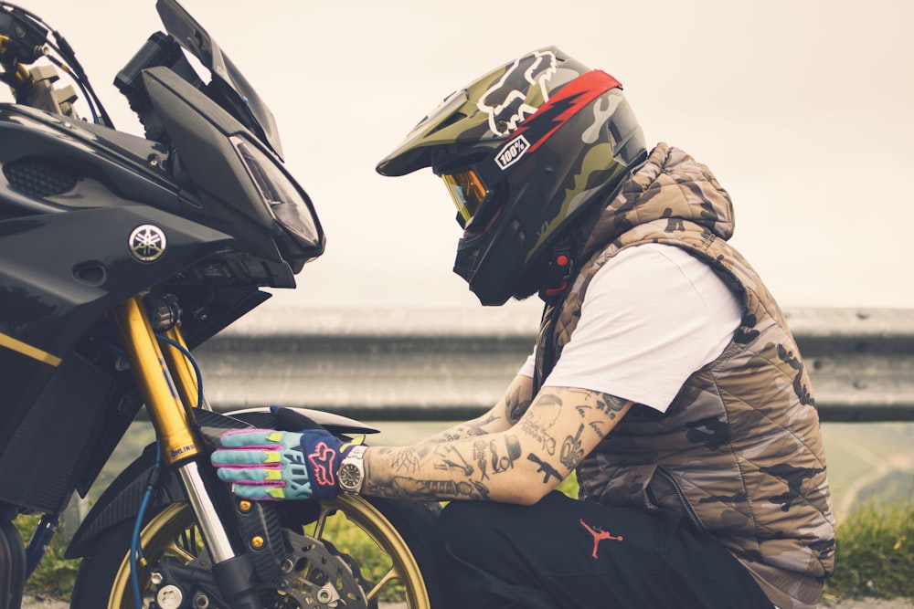 man in brown jacket and black helmet riding on motorcycle during daytime