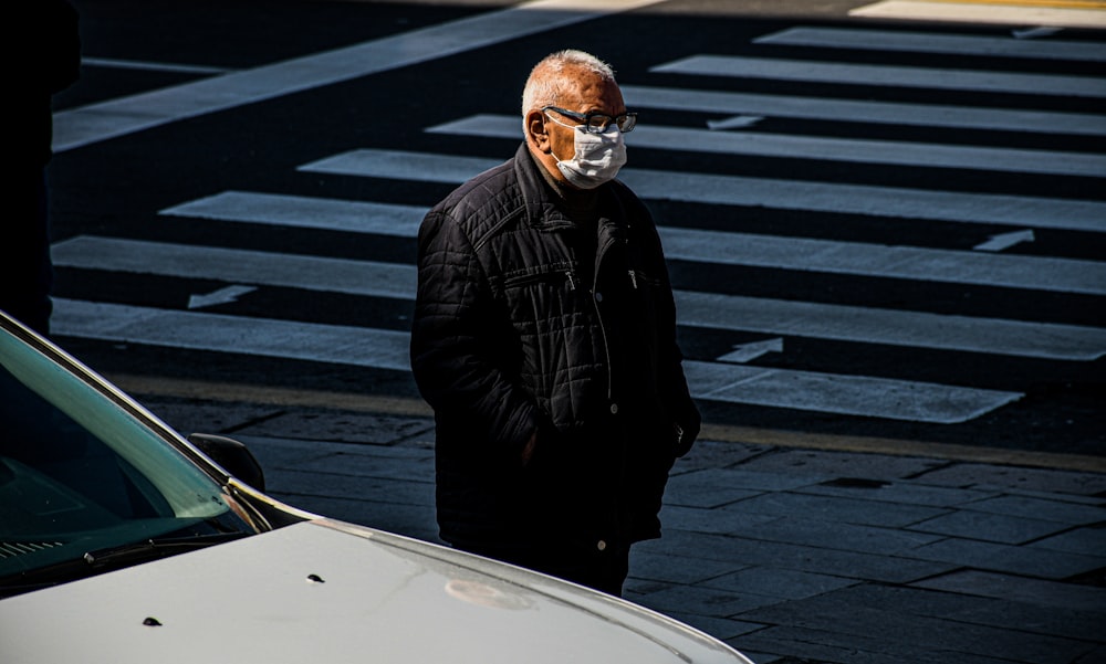man in black jacket wearing white goggles