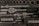 A collection of various metal tools neatly organized in a black foam case. Included are ratchets, sockets, and other attachments, each in their designated slot. The tools appear to be primarily made of metal, with some having rubberized handles.