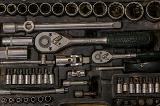 A sturdy metal garage tool chest with organized tools neatly arranged inside.