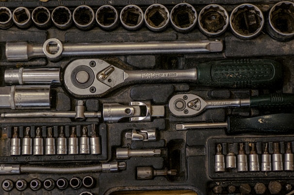Tools and measuring equipment neatly organized inside a rugged tool bag.