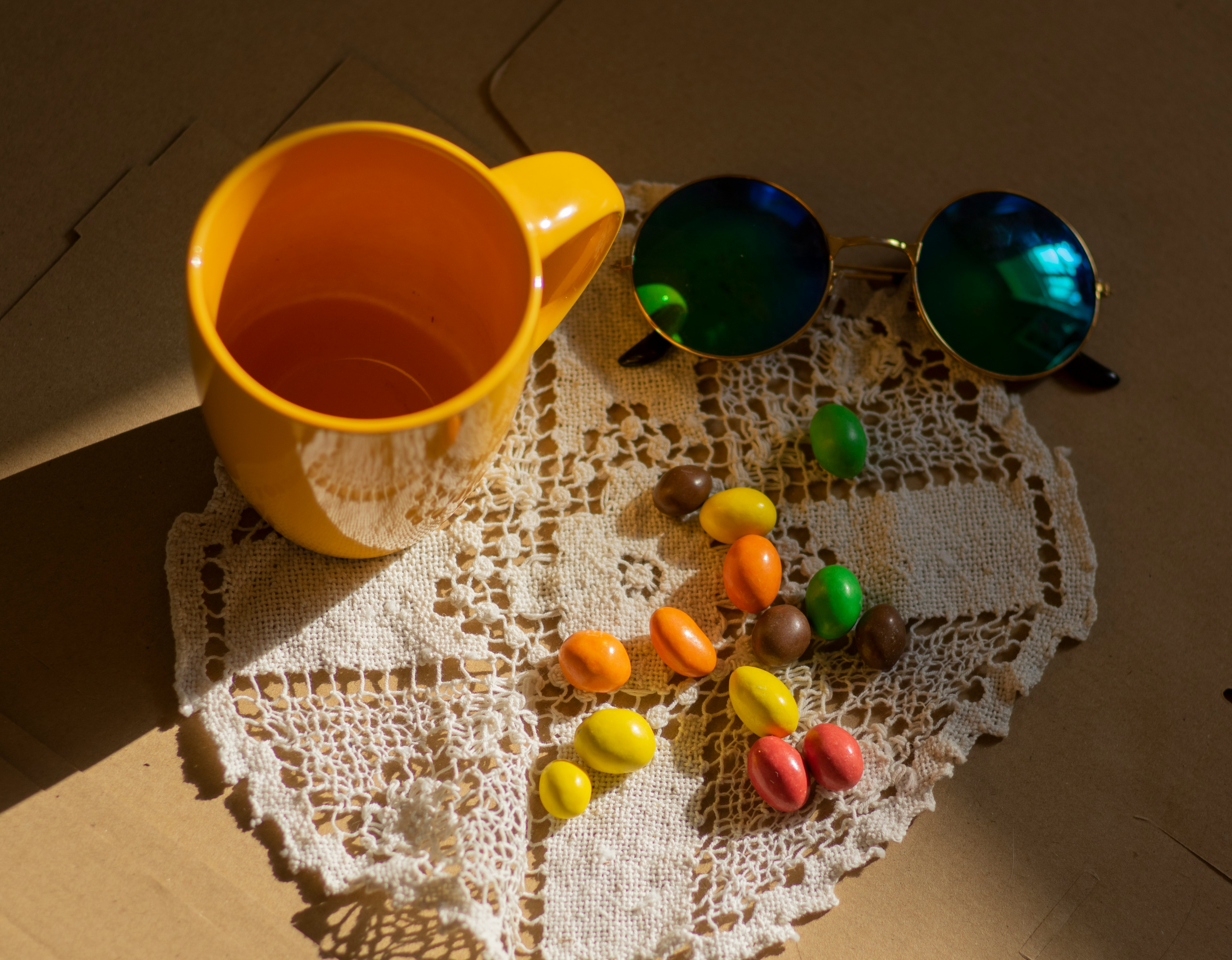 yellow ceramic mug beside blue and orange ceramic mug