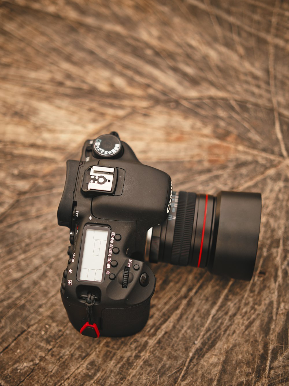 black nikon dslr camera on brown wooden table