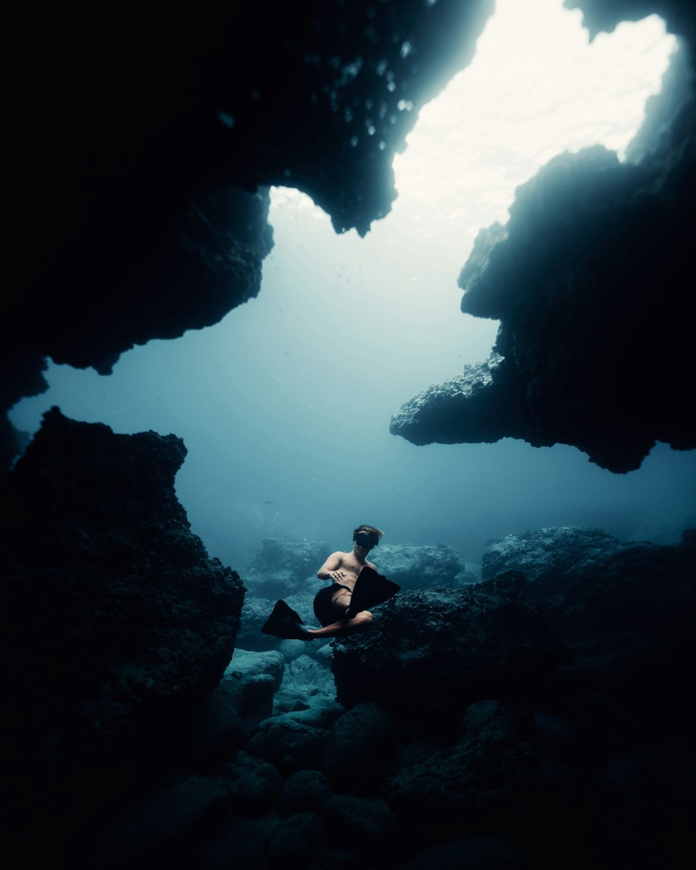 man in black shorts in water