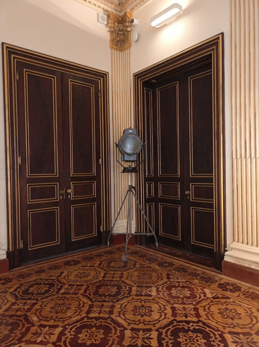 black and silver round floor lamp on brown and beige area rug