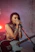 woman in brown tank top playing guitar