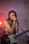 woman in brown tank top playing guitar