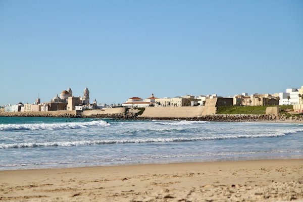 The beach, with the old city along the shore behind it — Cádiz, Spain