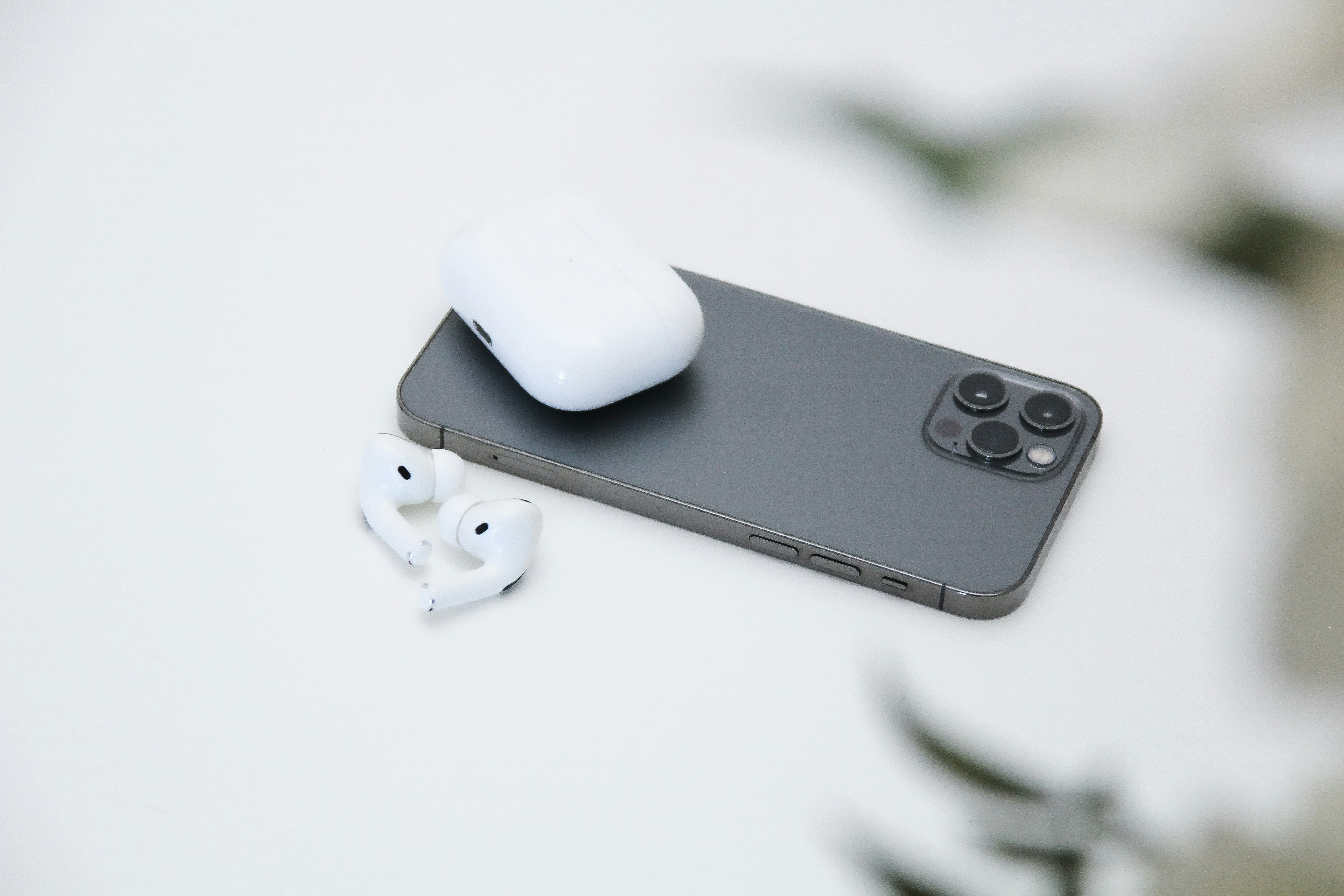 white apple airpods on white iphone