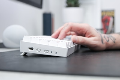 Close-up of hands typing rapidly on a mechanical keyboard.