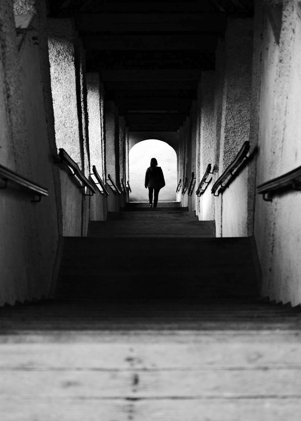 woman in black dress walking on the hallway