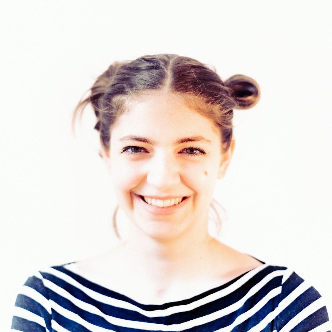 woman in black and white striped shirt smiling