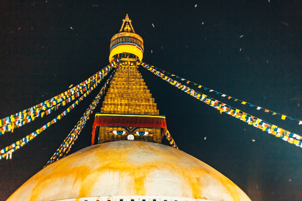 gold and red temple during night time