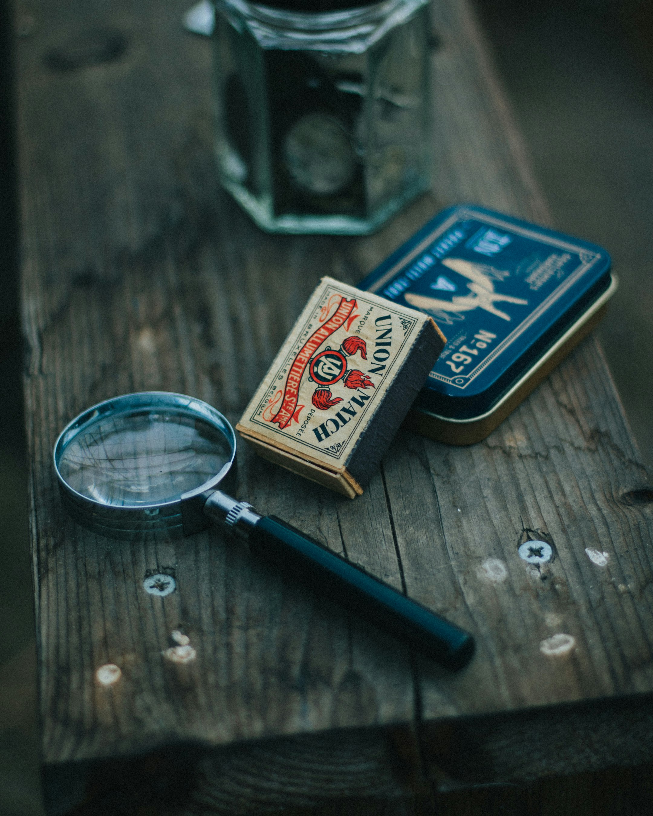 blue magnifying glass on brown wooden table