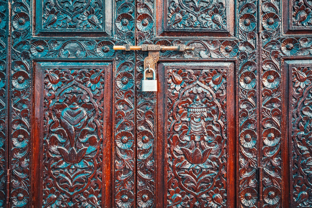 brown wooden door with padlock