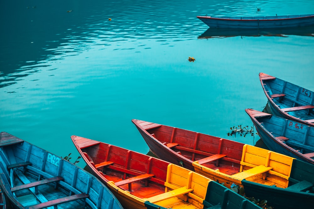 brown and red boat on body of water during daytime