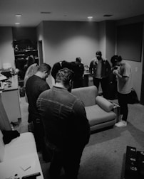 Group of pilgrims sharing a quiet prayer in shared accommodation.