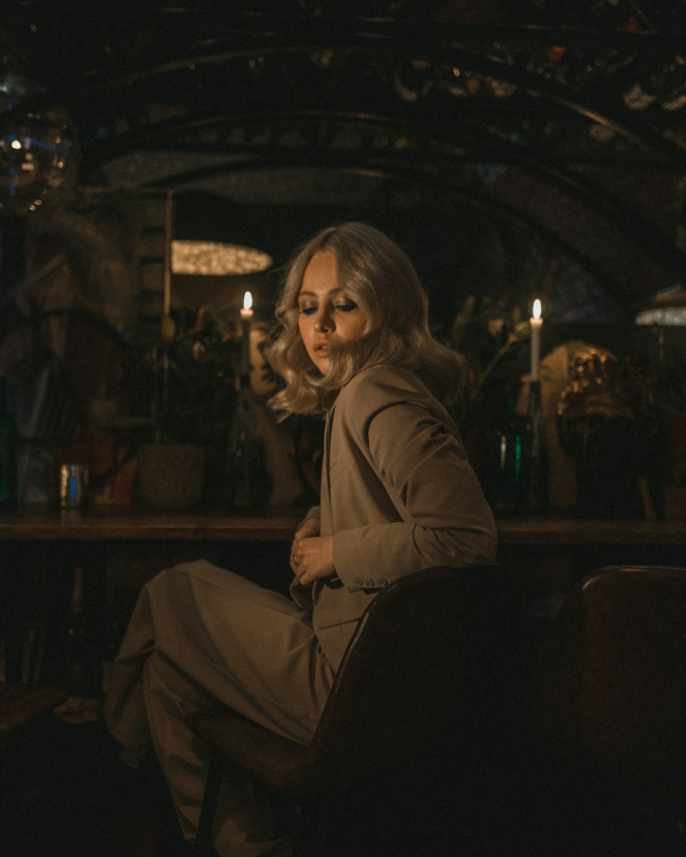 woman in brown coat sitting on chair