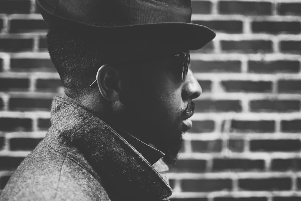 man in black hat and coat