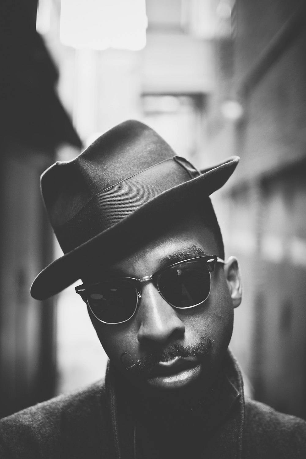 man wearing black sunglasses and hat