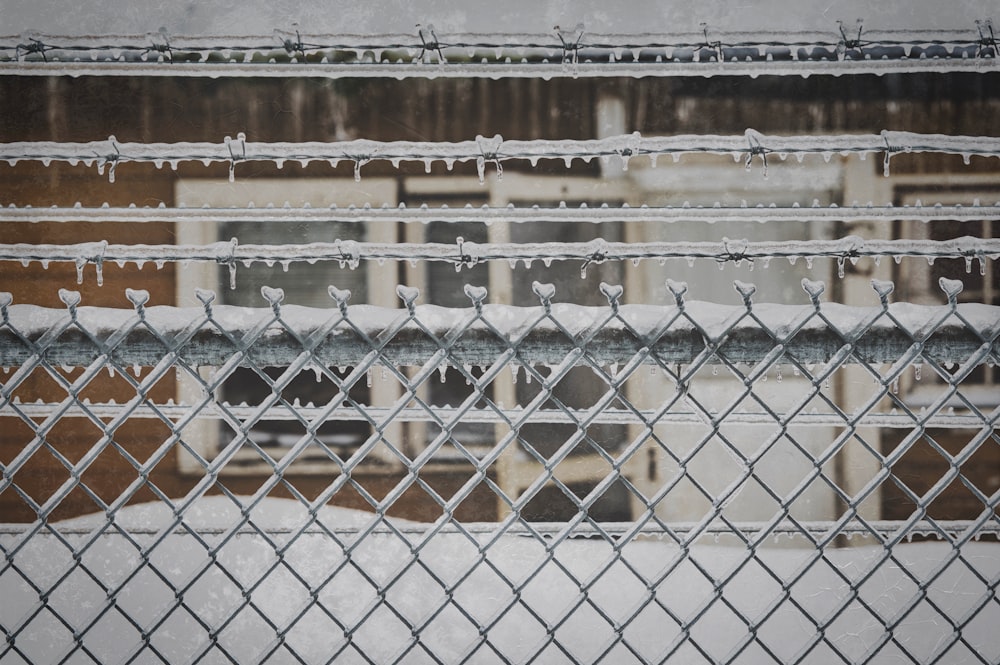 grey metal fence near building during daytime