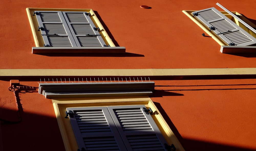 brown wooden window frame on orange painted wall