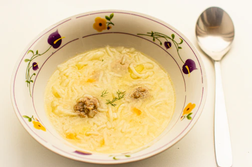 Steaming bowl of rich, creamy goulash with tender meat chunks and thick sauce, garnished with parsley.