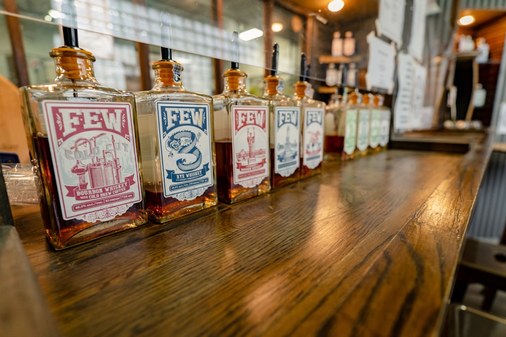 clear glass bottles on brown wooden table