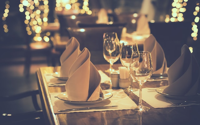 clear wine glasses and dinner place settings
