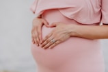 woman wearing gold ring and pink dress