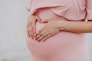 woman wearing gold ring and pink dress