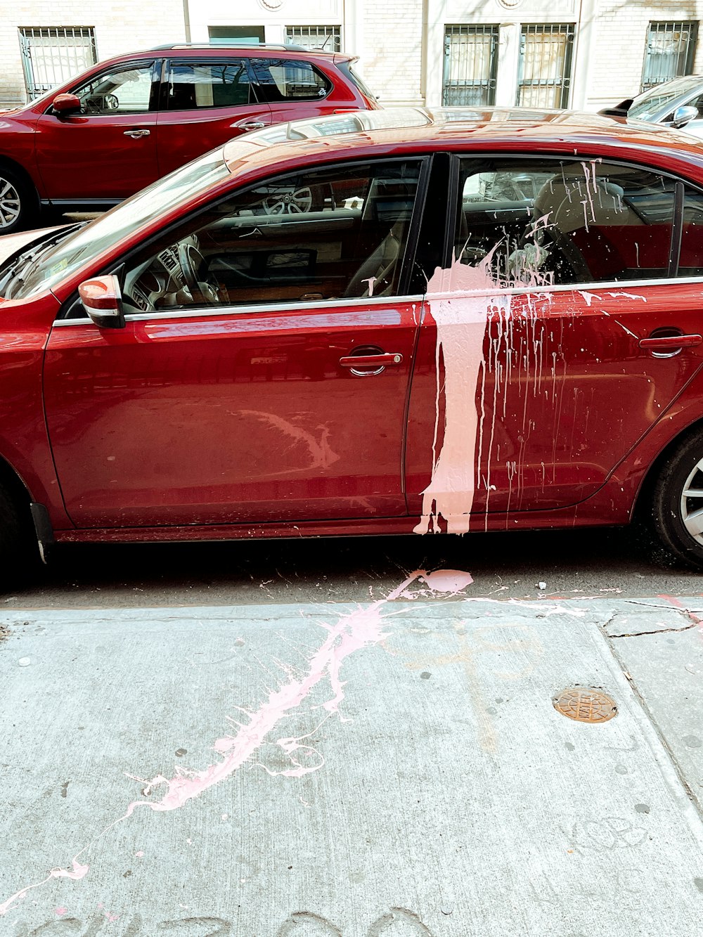 red 5 door hatchback on road during daytime