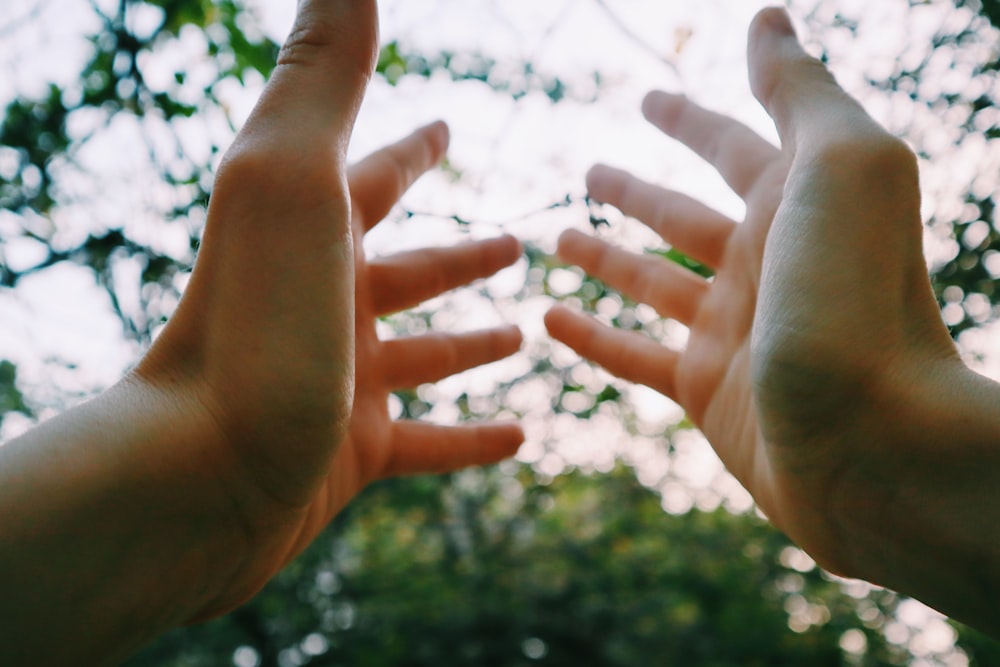 persons hand with water droplets