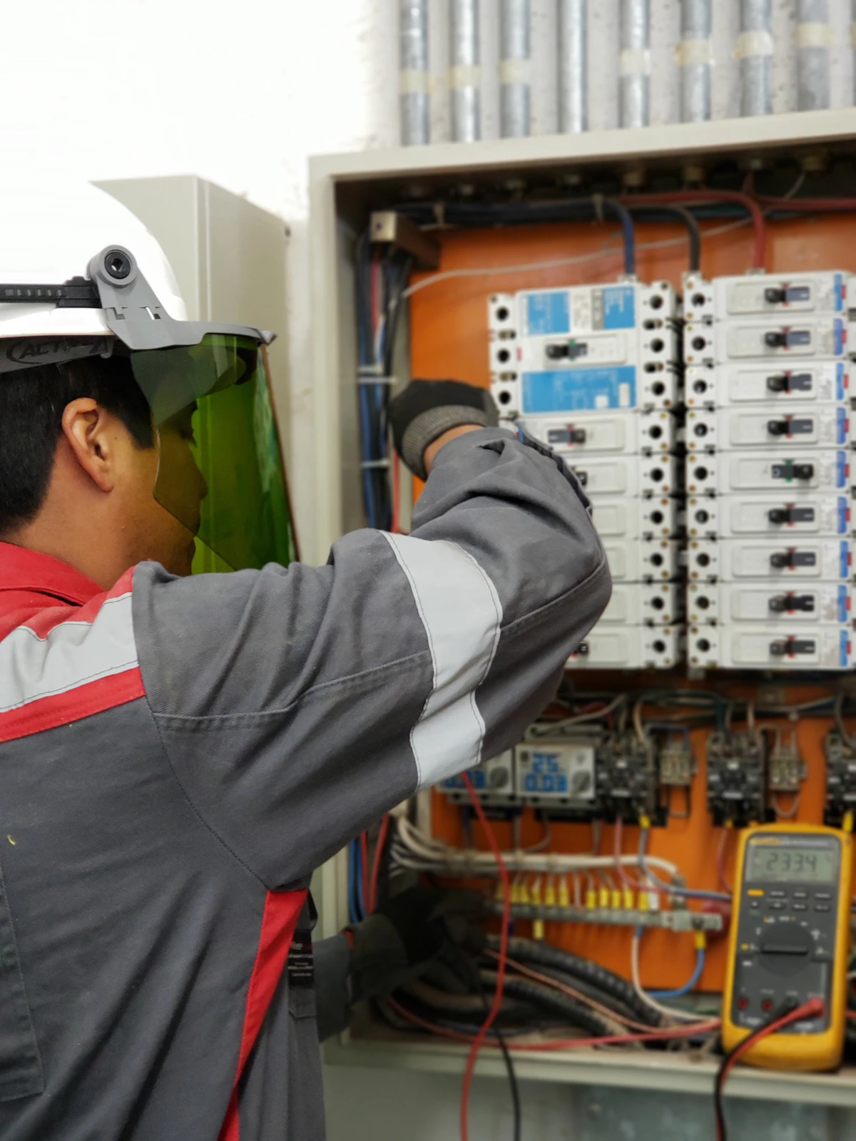 Licensed electrician inspecting a residential distribution board