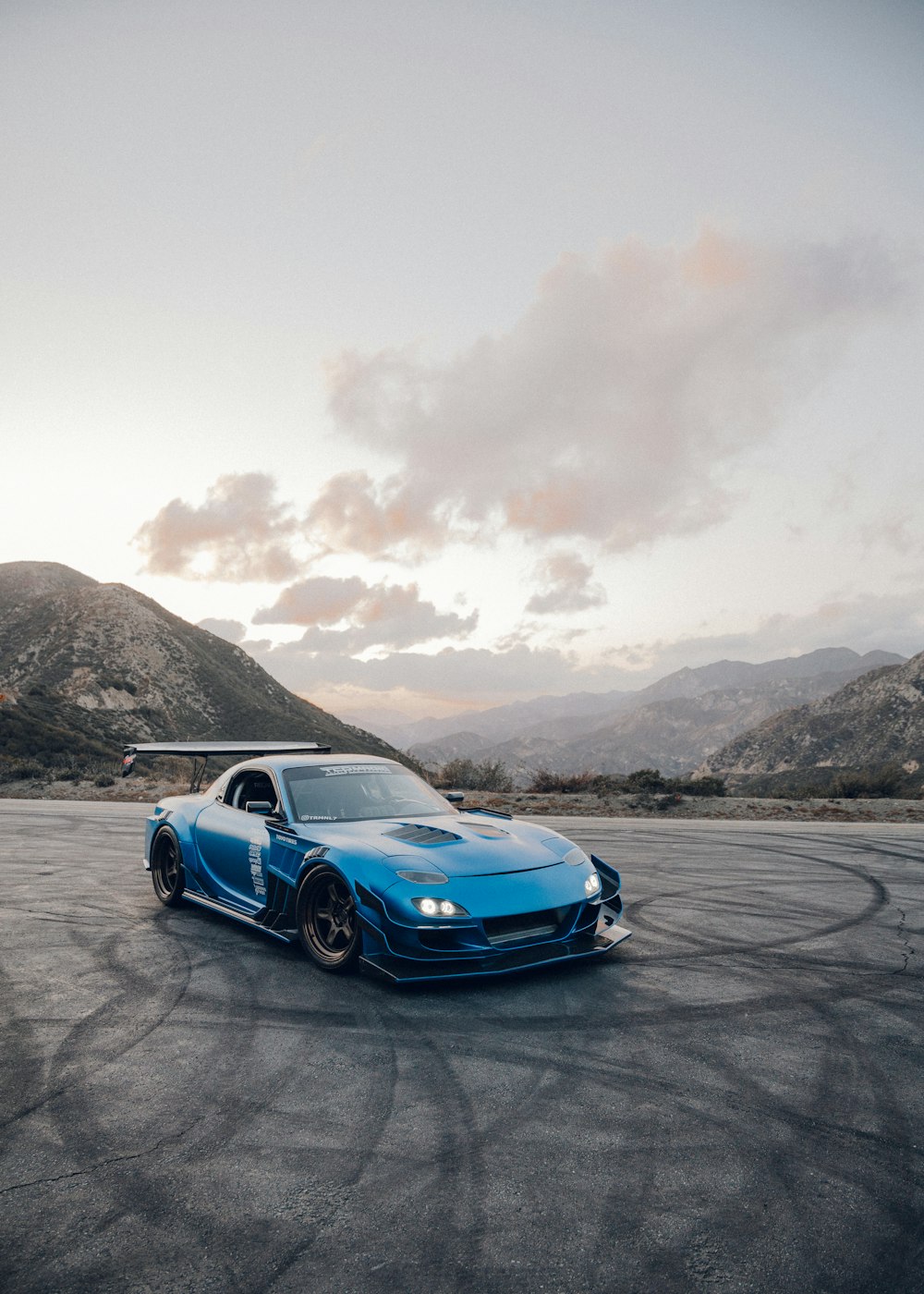 blue chevrolet camaro on beach during daytime