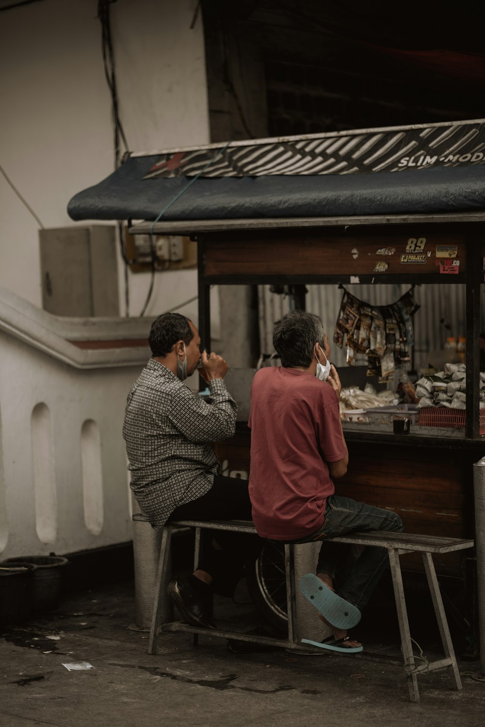 man in red jacket sitting on chair