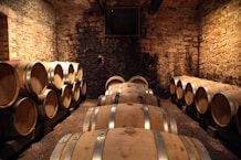 brown wooden barrels on brown brick wall